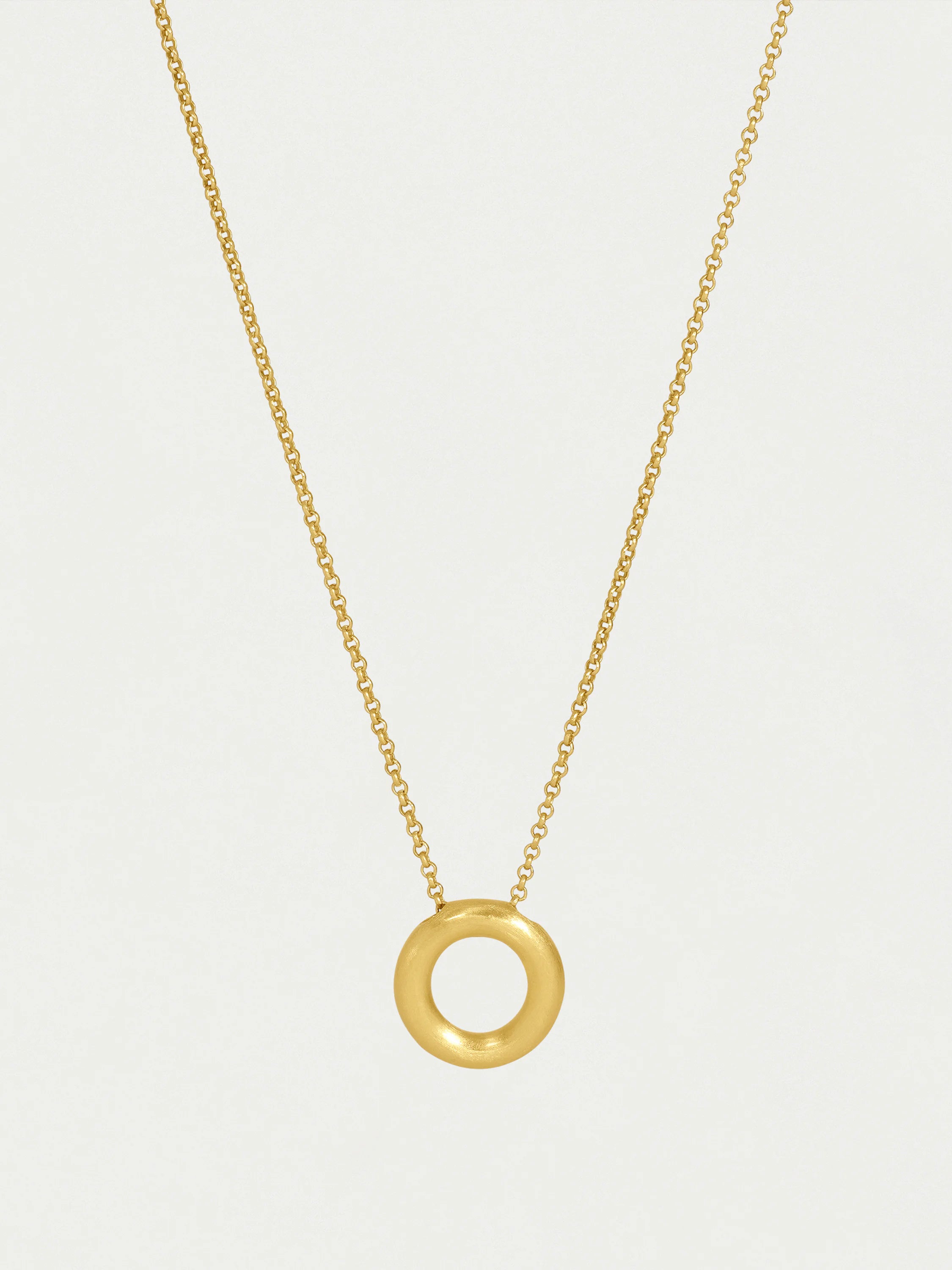 Gold chain necklace with a matte gold, thick ring pendant.