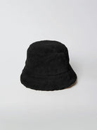 Black faux fur bucket hat.  Shows a slight hint of a light tan/beige underside of the brim.