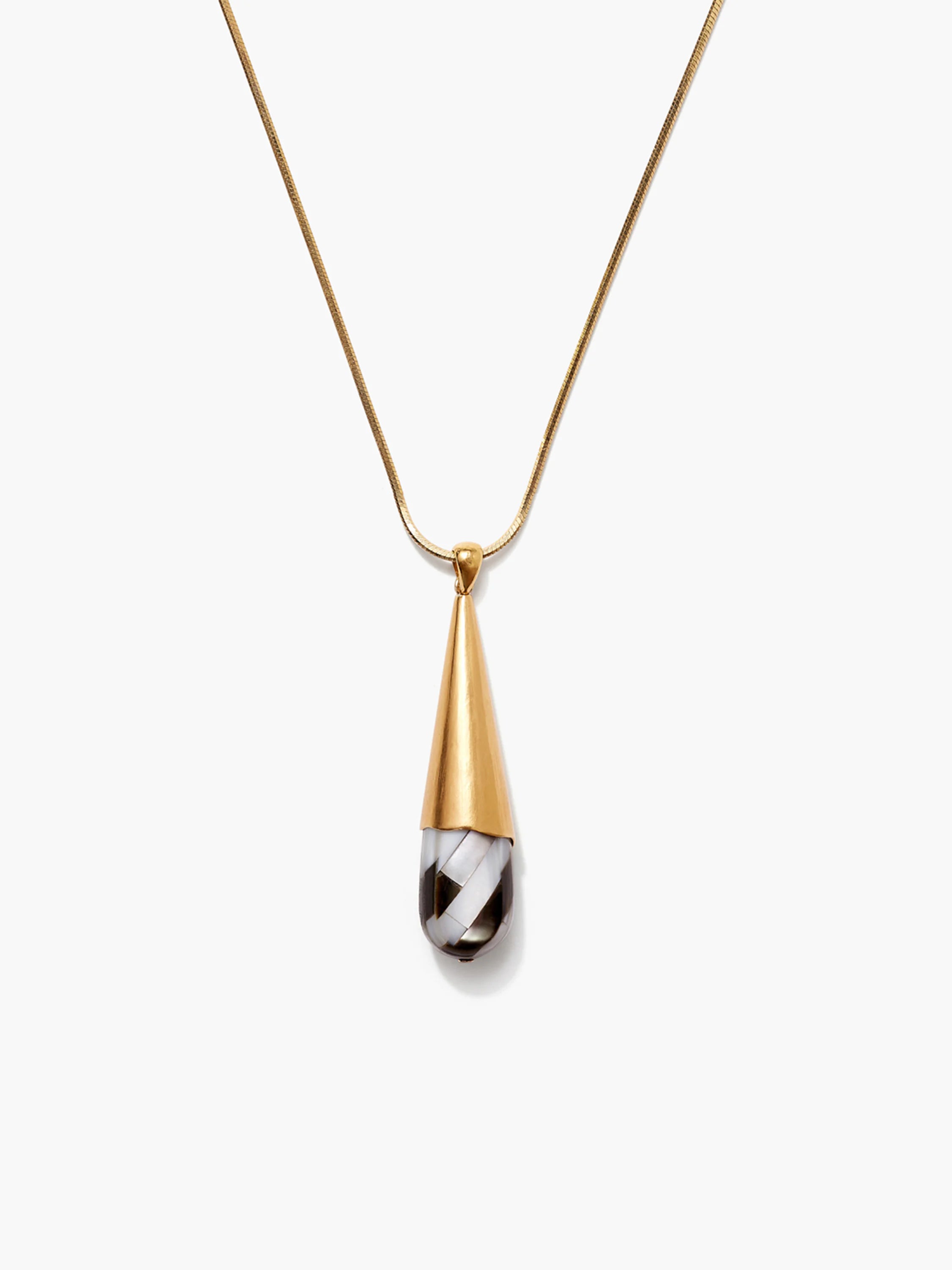 Gold chain necklace with teardrop pendant. Pendant is gold-toned metal encasing black and white patterned stone.