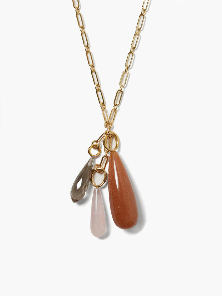 Gold chain necklace with three teardrop-shaped stones: smoky gray, light pink, and reddish-brown.