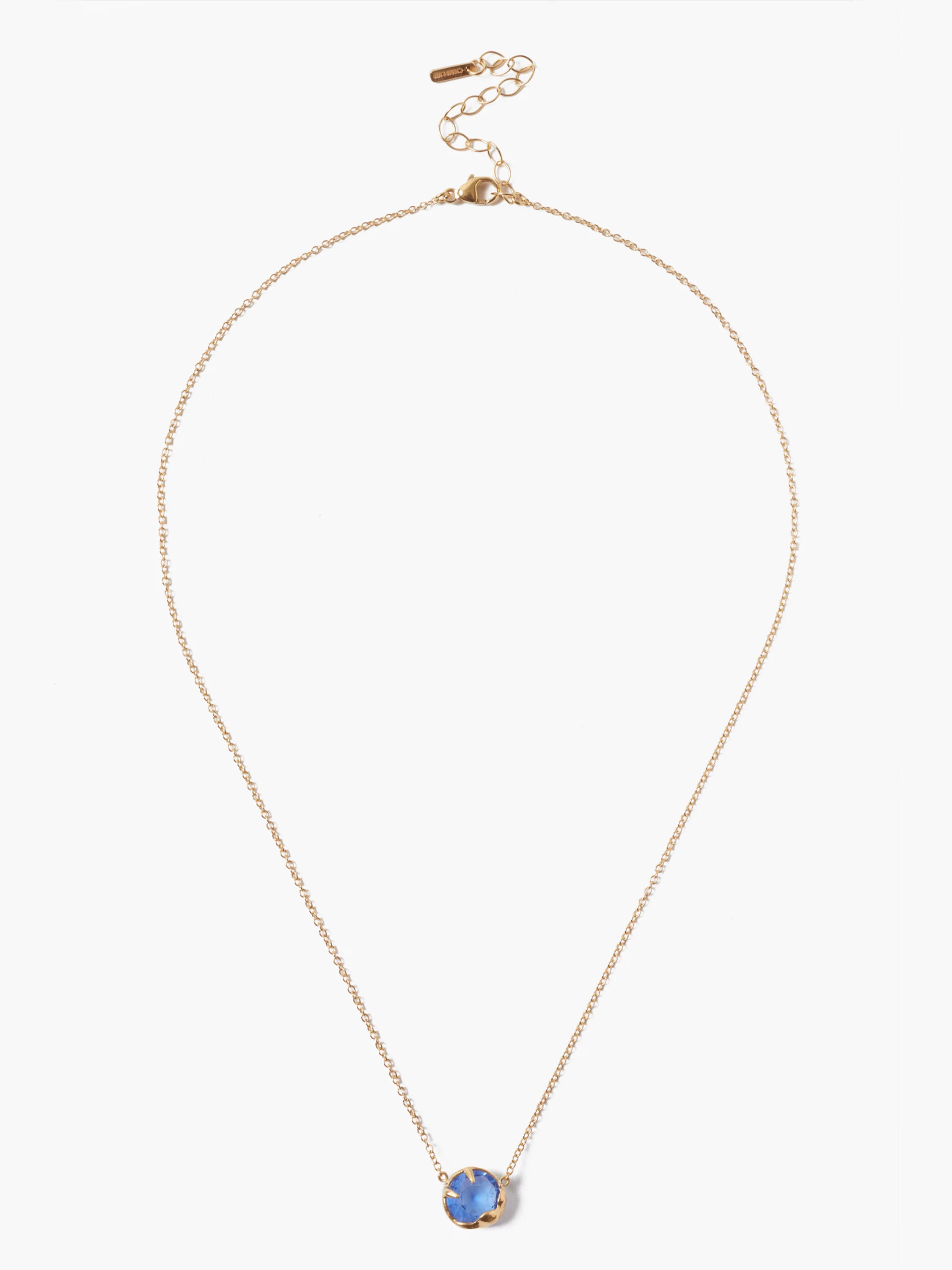 Gold chain necklace with a single, round, light blue stone pendant.