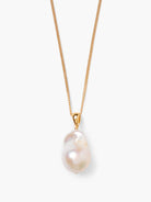 Gold chain necklace with a single, iridescent off-white baroque pearl drop pendant.