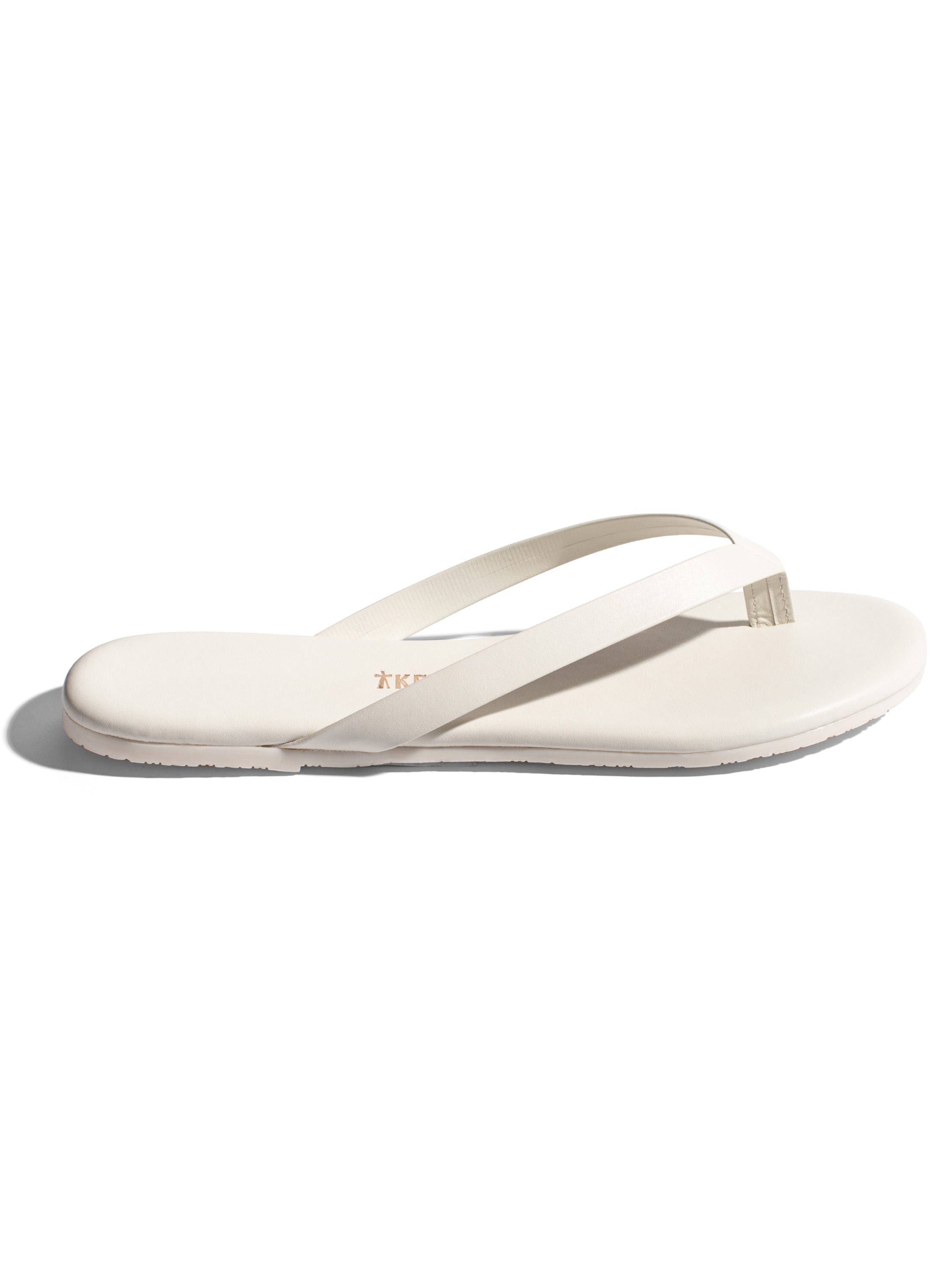 Minimalist off-white leather flip-flops with thin straps and a flat, smooth sole.