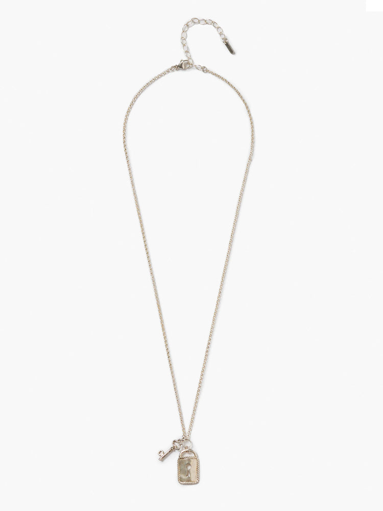 Silver necklace with thin chain, small key, and rectangular lock pendant with keyhole and braided border.