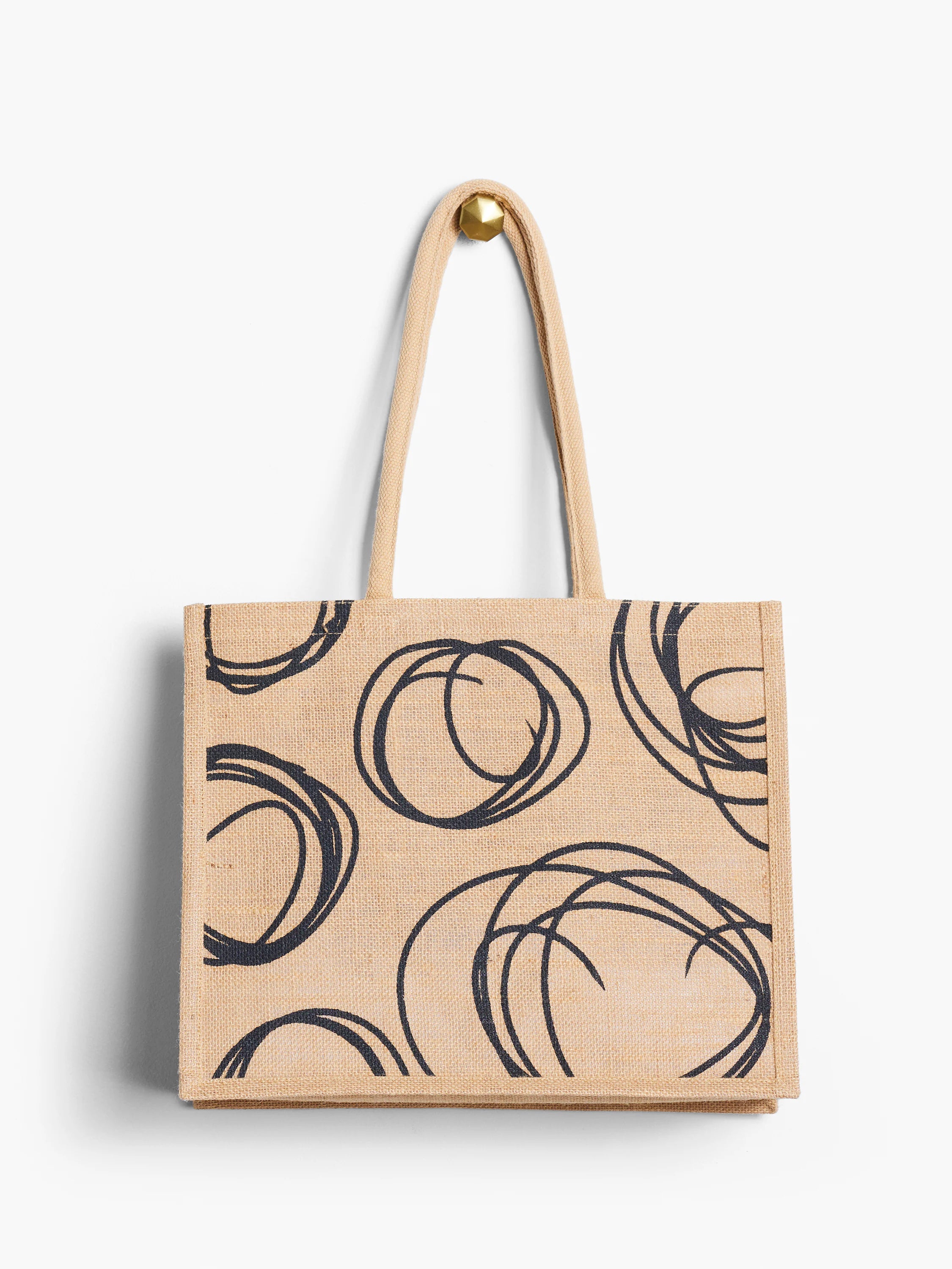 Natural tan jute tote bag with black abstract circle pattern.