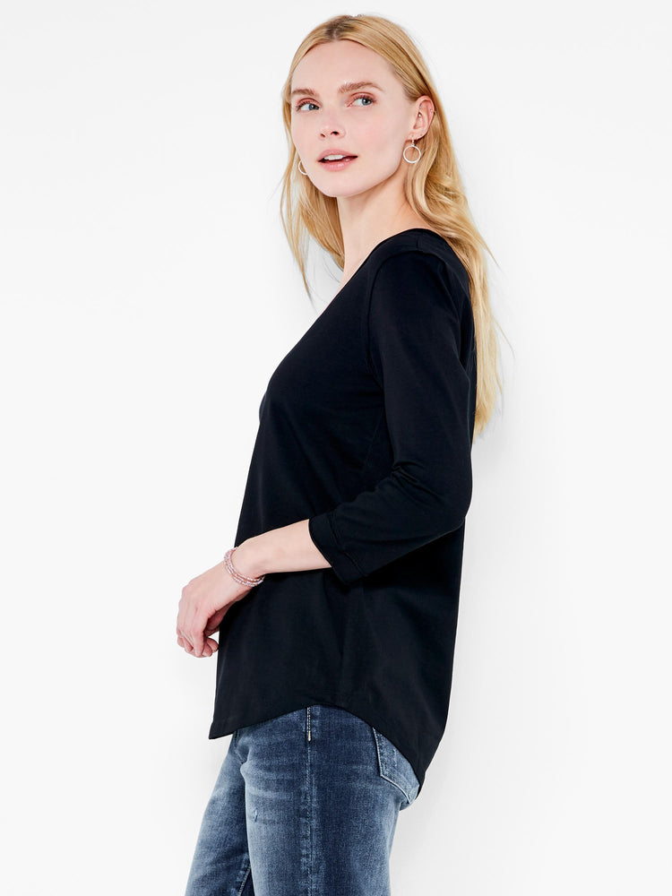 A model wears a black relaxed fit top with three quarter length sleeves and a curved hem.