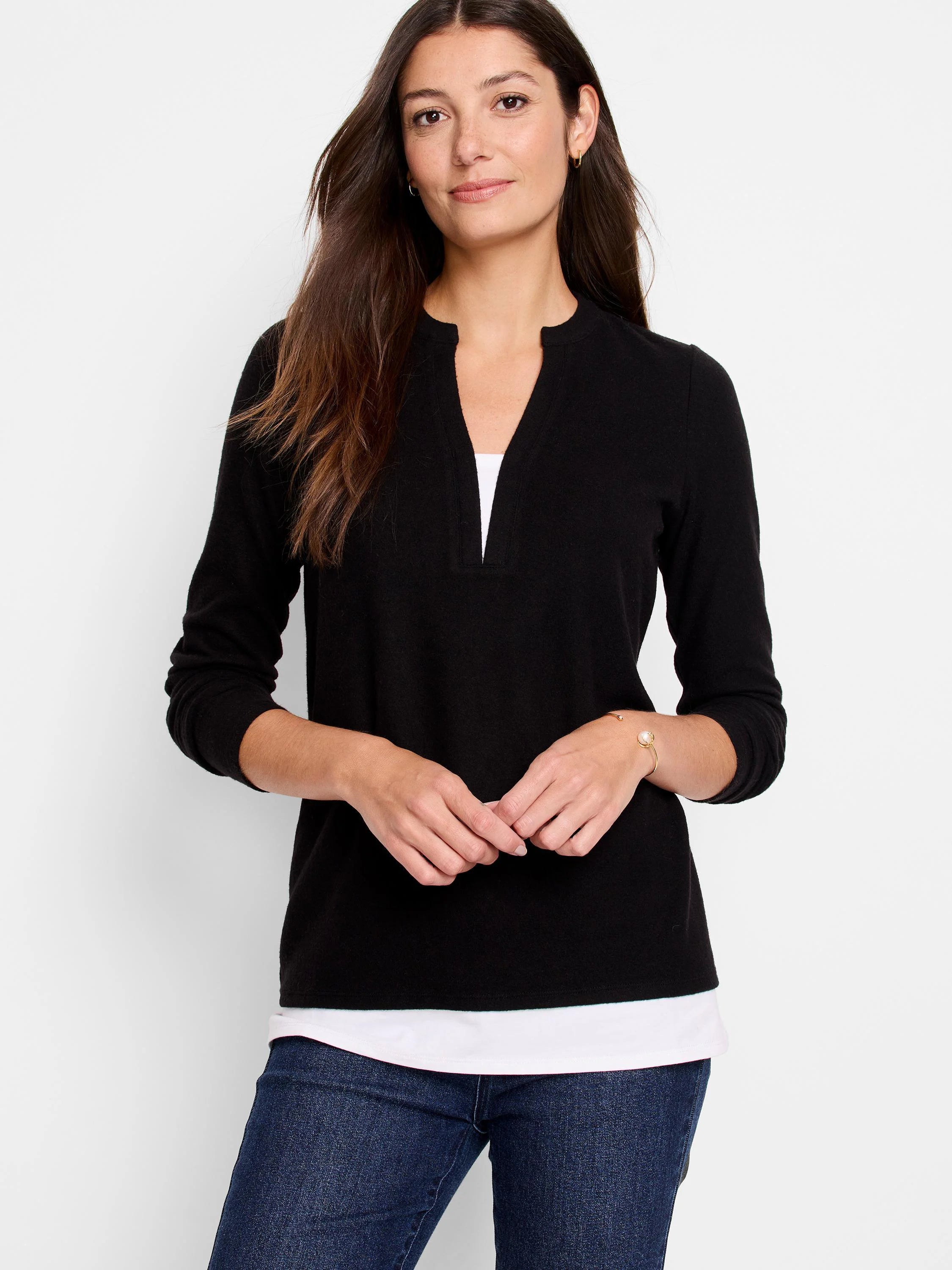Black long-sleeve top with a small V-neck. A hint of white underlay is visible at the neckline.