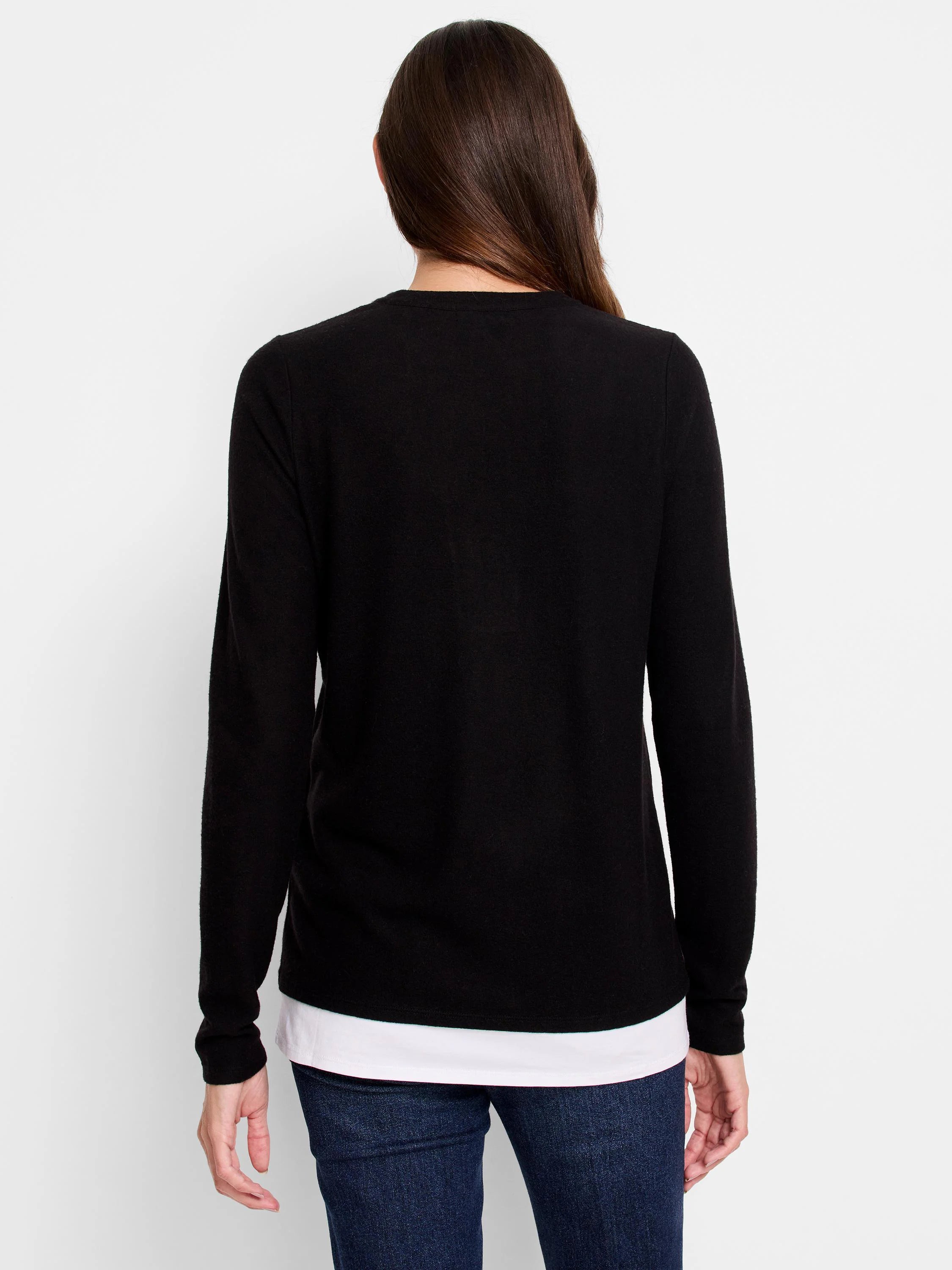 Black long-sleeve top layered over white, shown from the back.