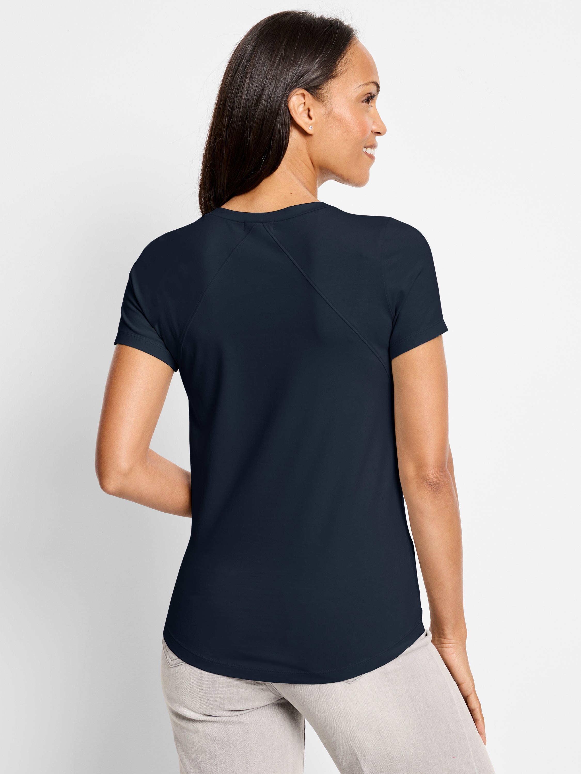 A semi-fitted navy short-sleeve top features angled back seams, a high crew neck, and a curved hem.