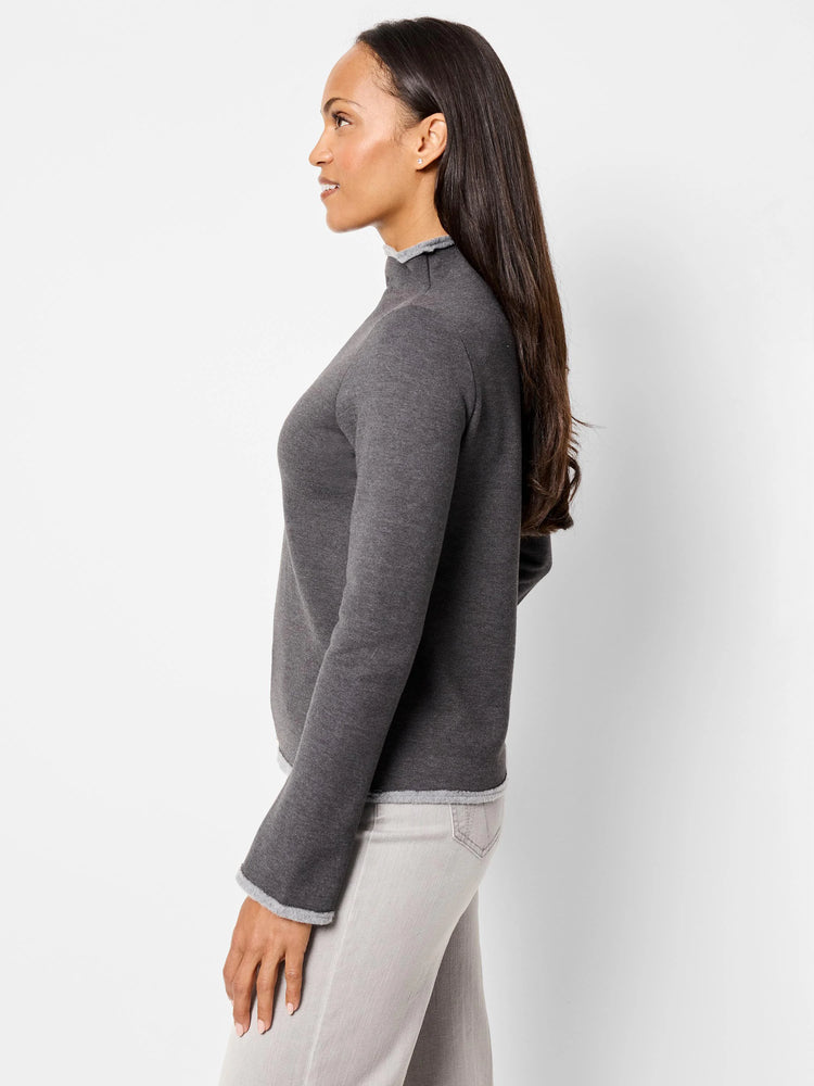 Dark gray mock neck top with lighter gray trim at cuffs and hem. Long sleeves.