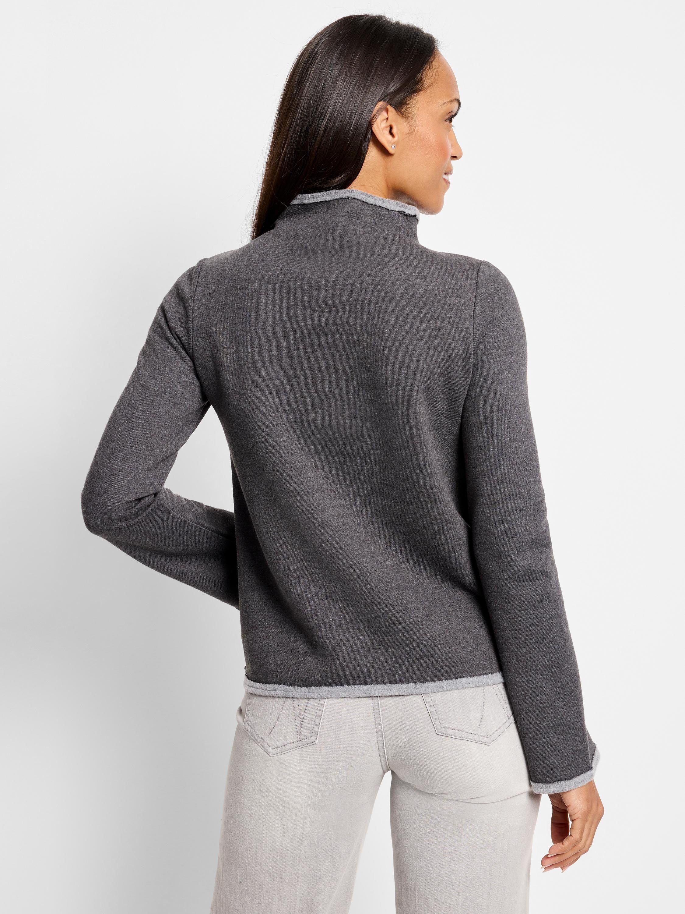 Dark grey mock neck top with lighter grey trim at neck and sleeves. Long sleeves. Back view.