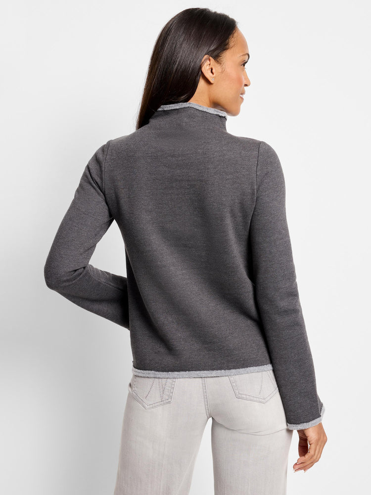 Dark grey mock neck top with lighter grey trim at neck and sleeves. Long sleeves. Back view.