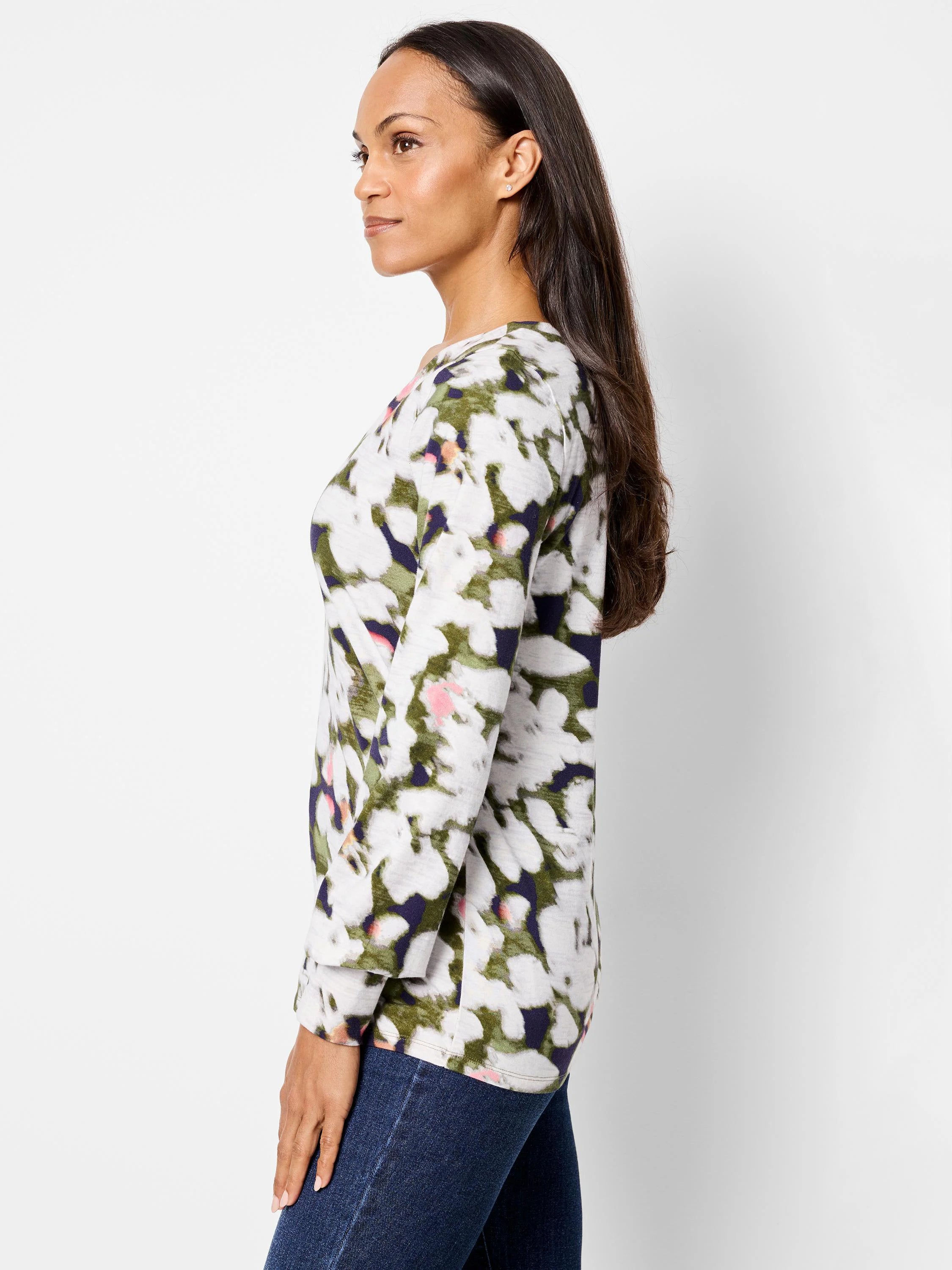 Long-sleeve top, off-white base with blurred green, dark purple, and pink petal-like patterns. Three-quarter sleeves.