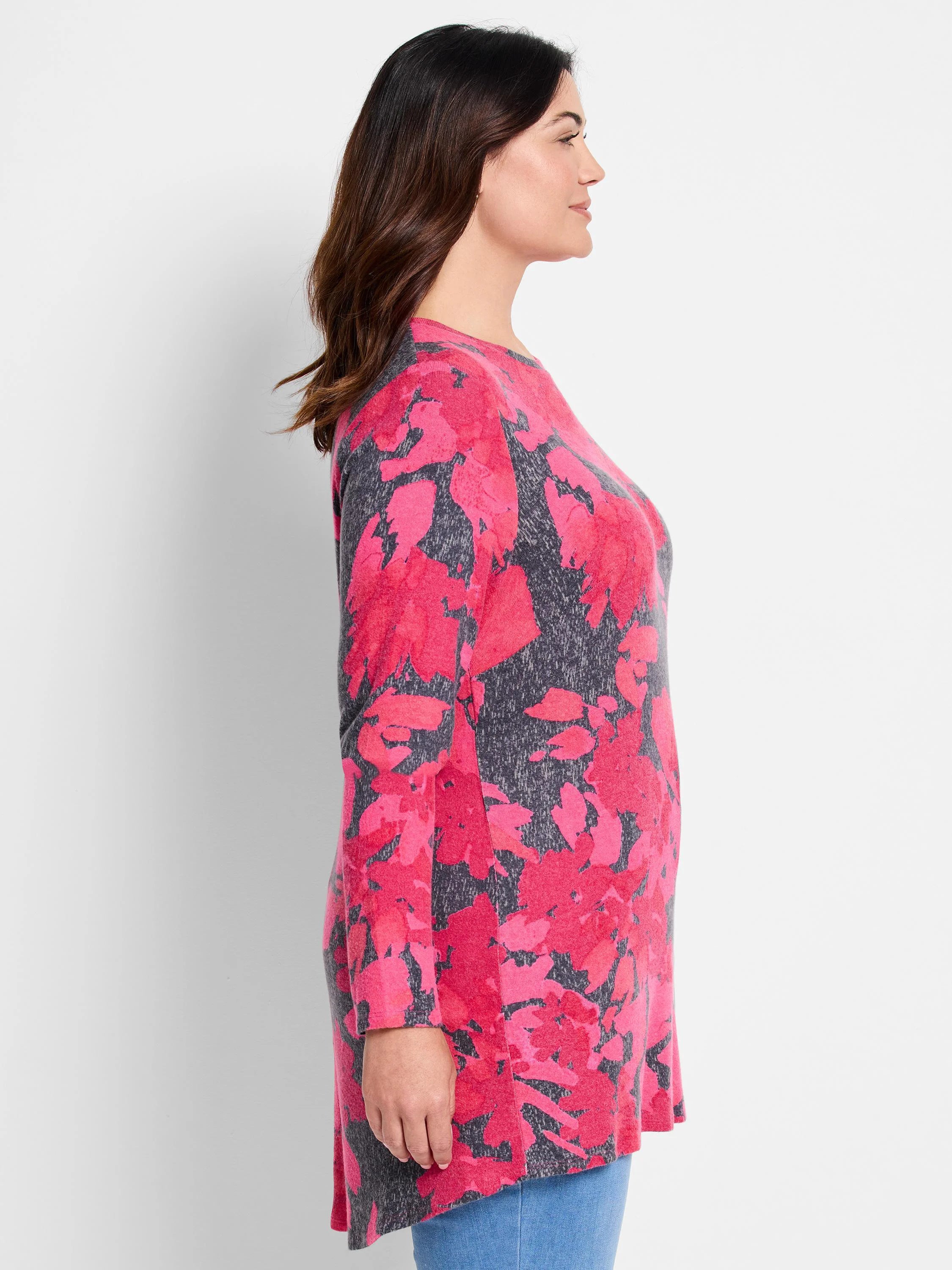 Long-sleeve shirttail tee with pink floral pattern on a gray background.  Curved hemline.
