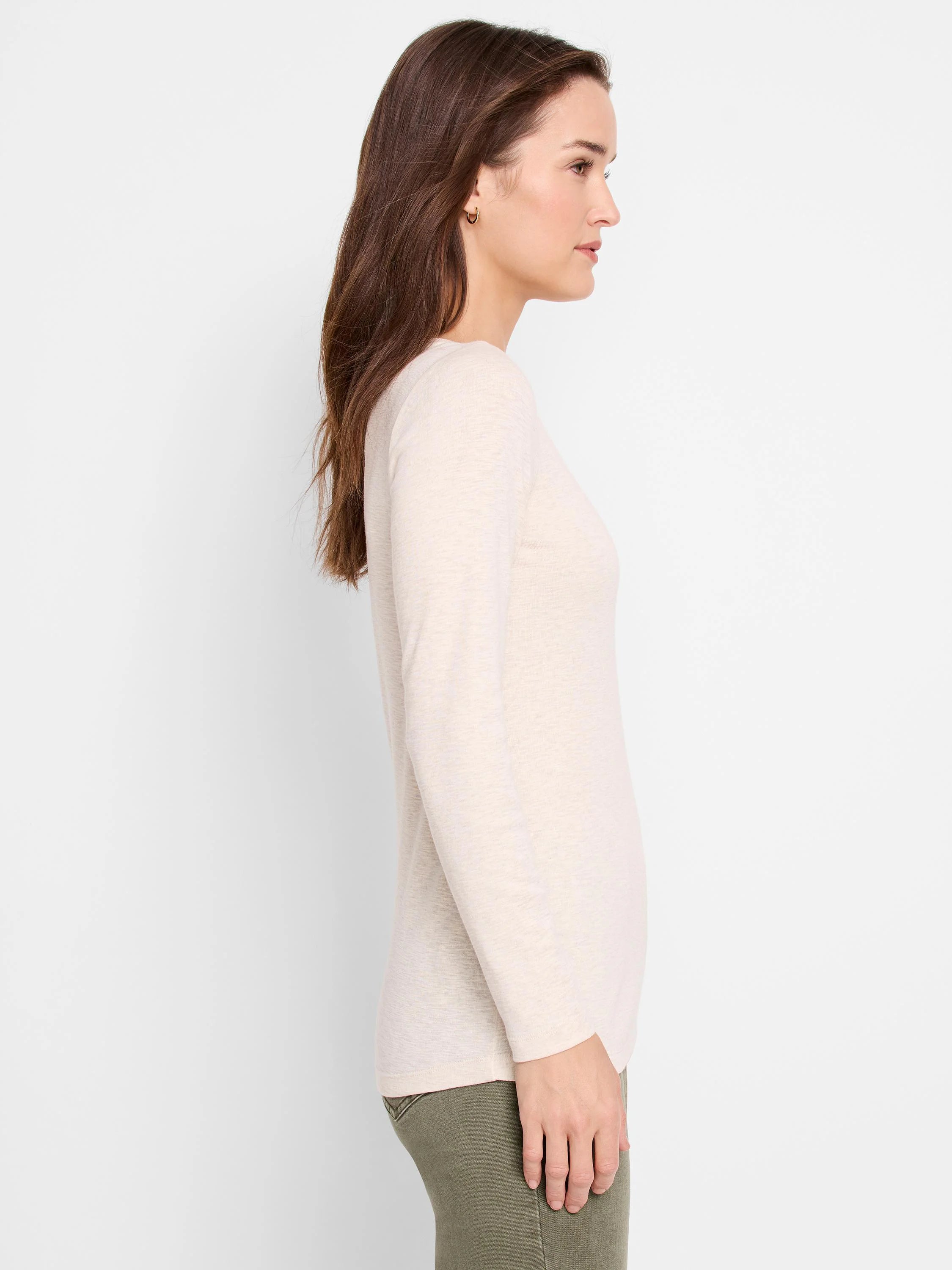 Off-white, long-sleeved shirt; side profile view. Textured fabric.
