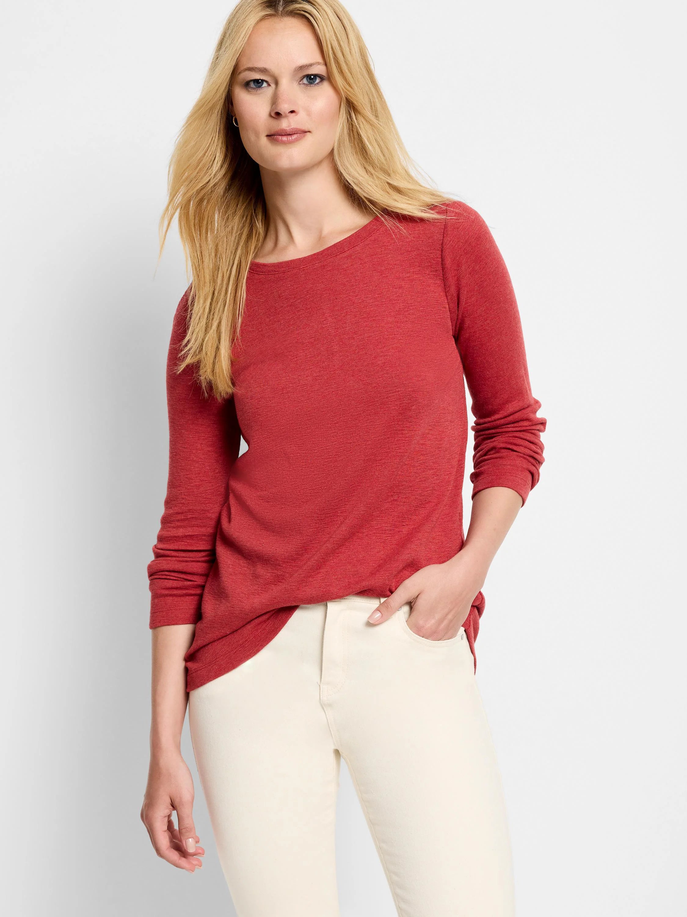 Red long-sleeve boatneck shirt; textured fabric. Model wears off-white pants.