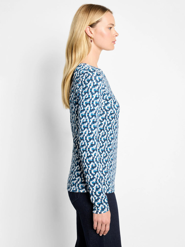 Blue and white long sleeve boat tee. Abstract geometric print with shades of dark blue, teal, and white.