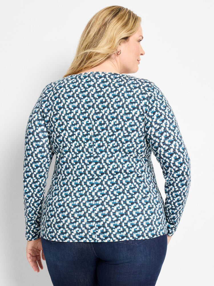Long-sleeve tee with cream, dark blue, and teal fragmented pattern.