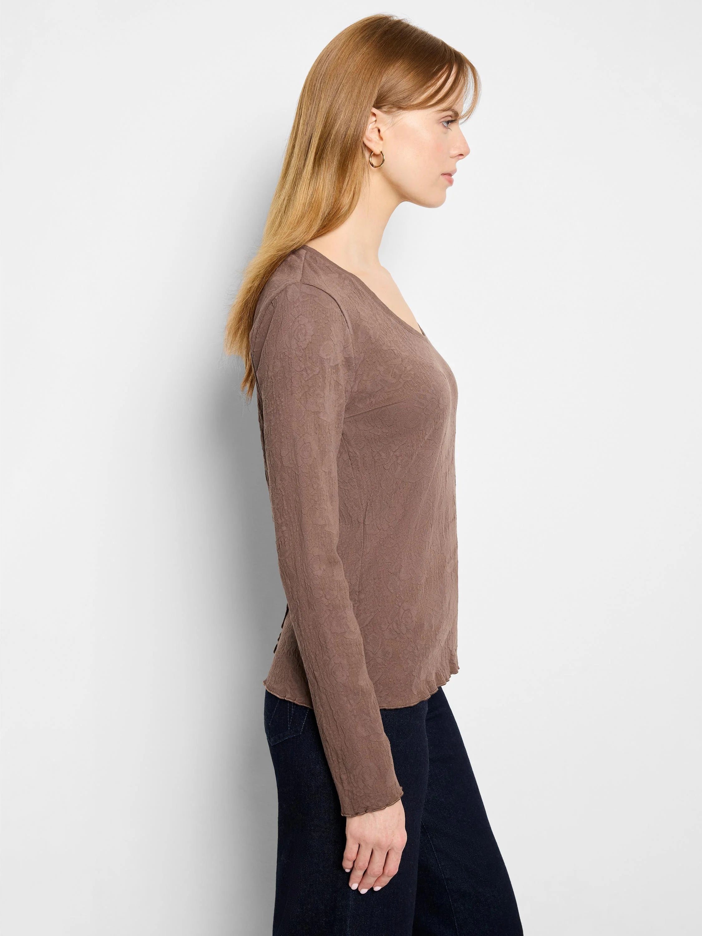 Brown, long-sleeved V-neck knit shirt with textured surface. Slightly scalloped hem.