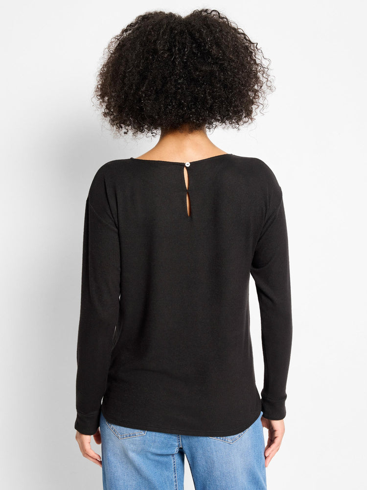 Black long-sleeved top, relaxed fit. Features a wide back neckline with a keyhole opening secured by a white button.