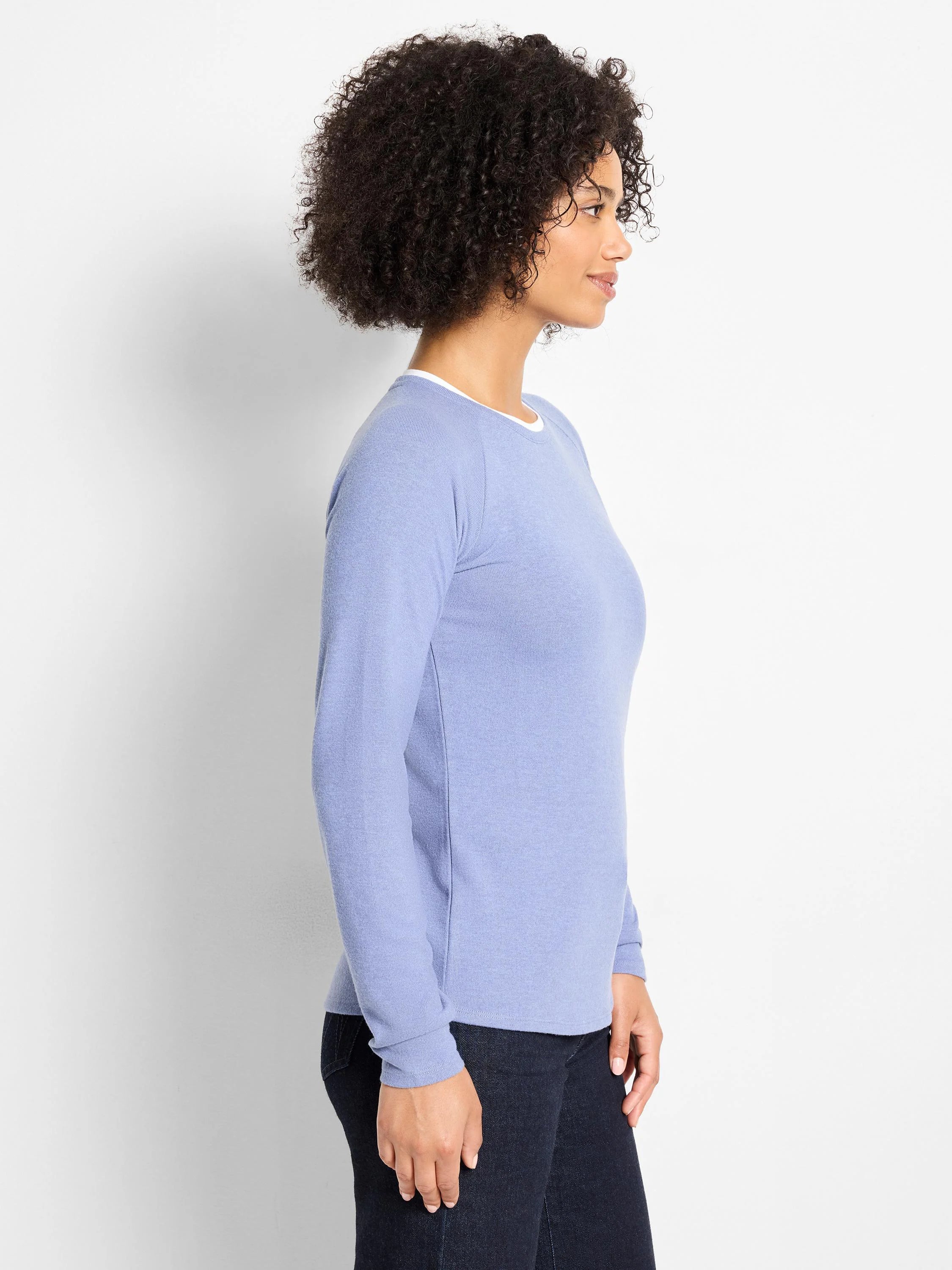 Light blue long-sleeved top with a white crew neck trim, suggesting a double-layered appearance.
