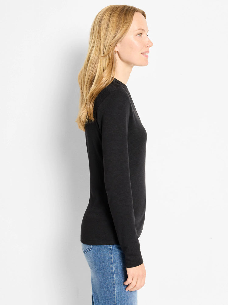 Black long-sleeve henley shirt shown on a model. Side profile.