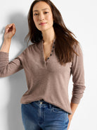 Brown long-sleeve henley shirt with dark buttons;  model shown wearing it.