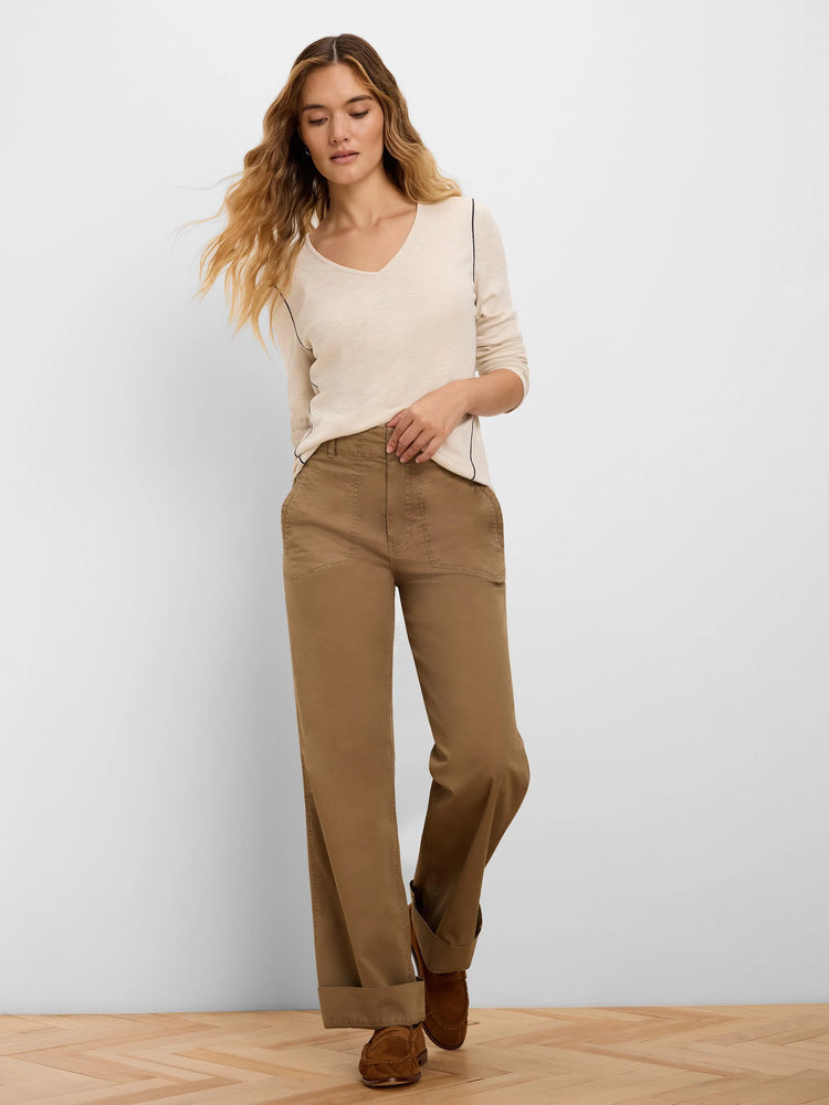 Cream long sleeve V-neck tee with black contrast piping along raglan seams.