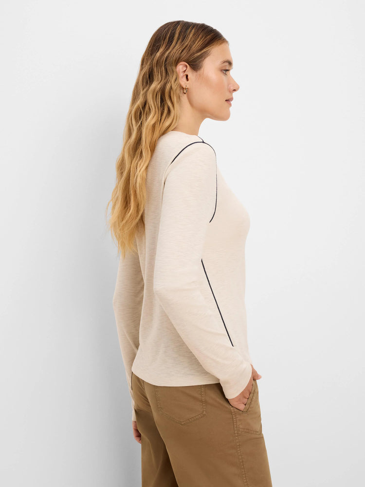 Pale beige long sleeve tee with dark piping on shoulder and side seams.