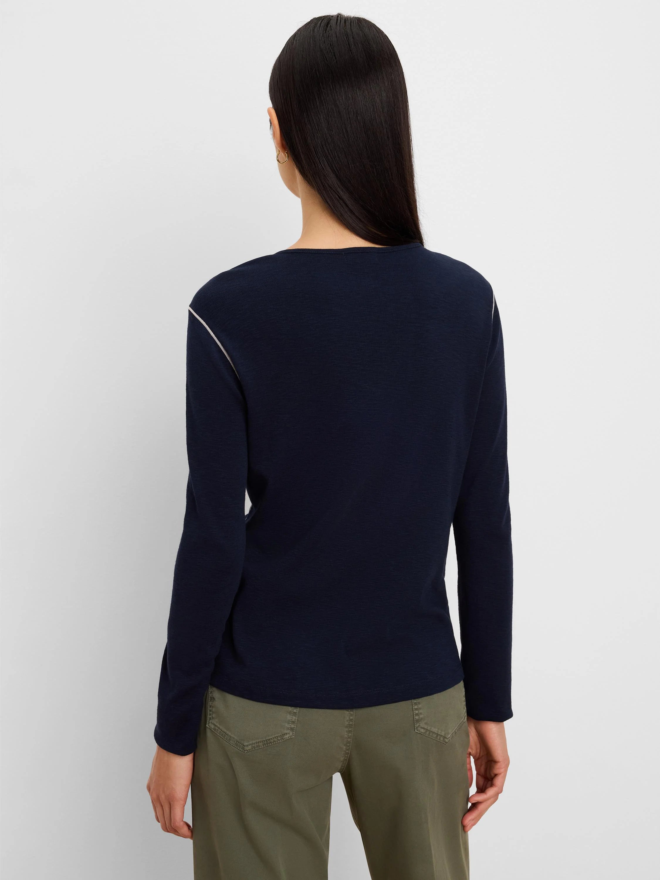 Dark navy long sleeve tee with subtle textured fabric and a thin white stripe along the shoulder and outer arm.
