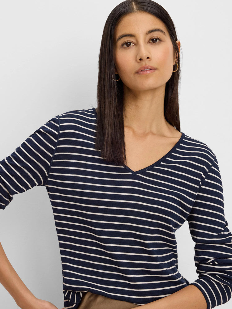 Navy blue and white horizontally striped long sleeve tee with a V-neck.
