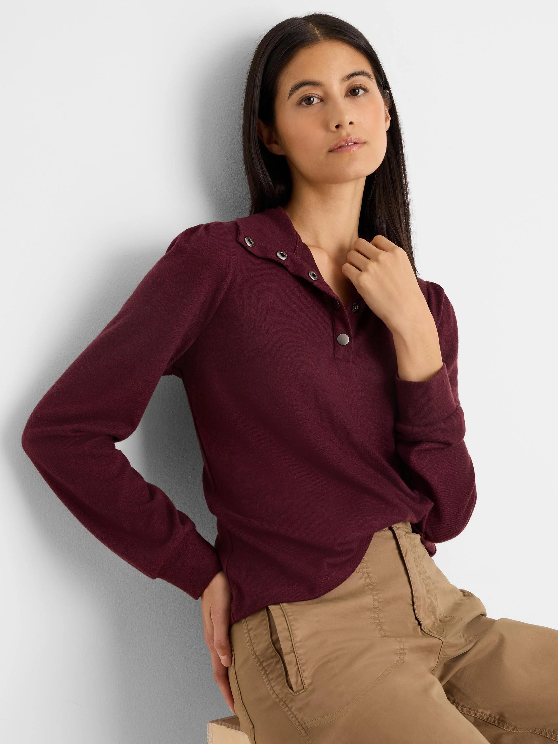 Maroon knit tee with subtle puff long sleeves, collared snap placket, and silver-toned snaps.