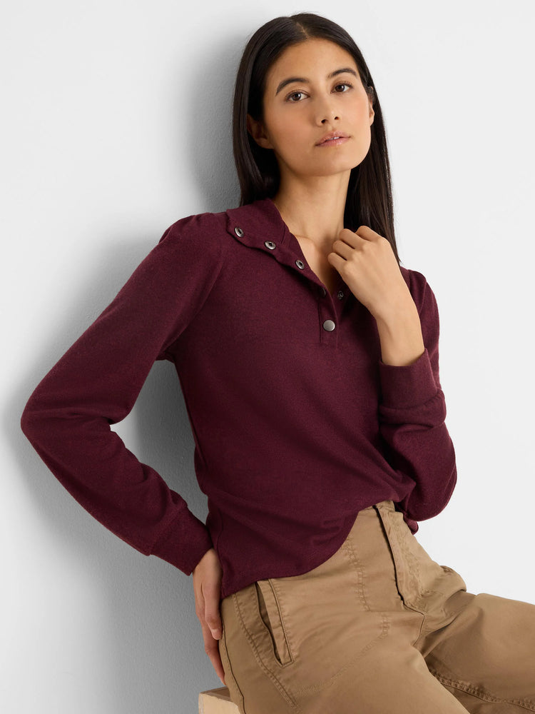 Maroon knit tee with subtle puff long sleeves, collared snap placket, and silver-toned snaps.