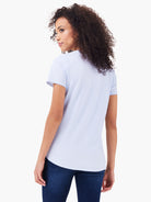 Light blue short sleeve crew neck t-shirt with shirt tail hem, shown from behind.