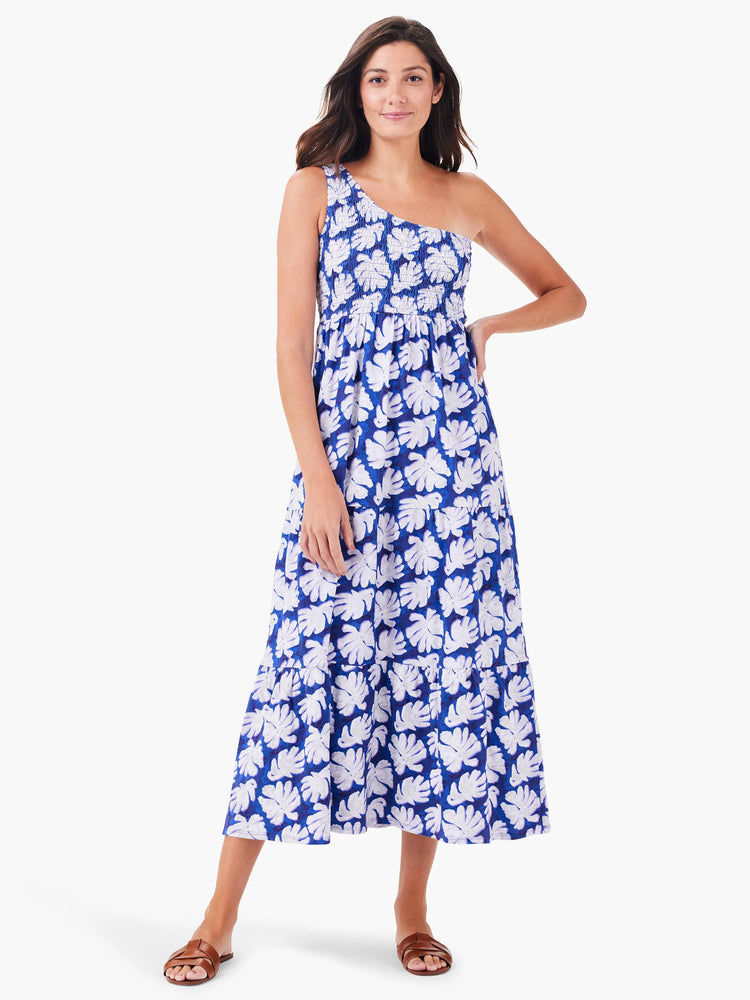 One-shoulder, smocked bodice midi dress. Blue background with white leaf print. Tiered skirt.