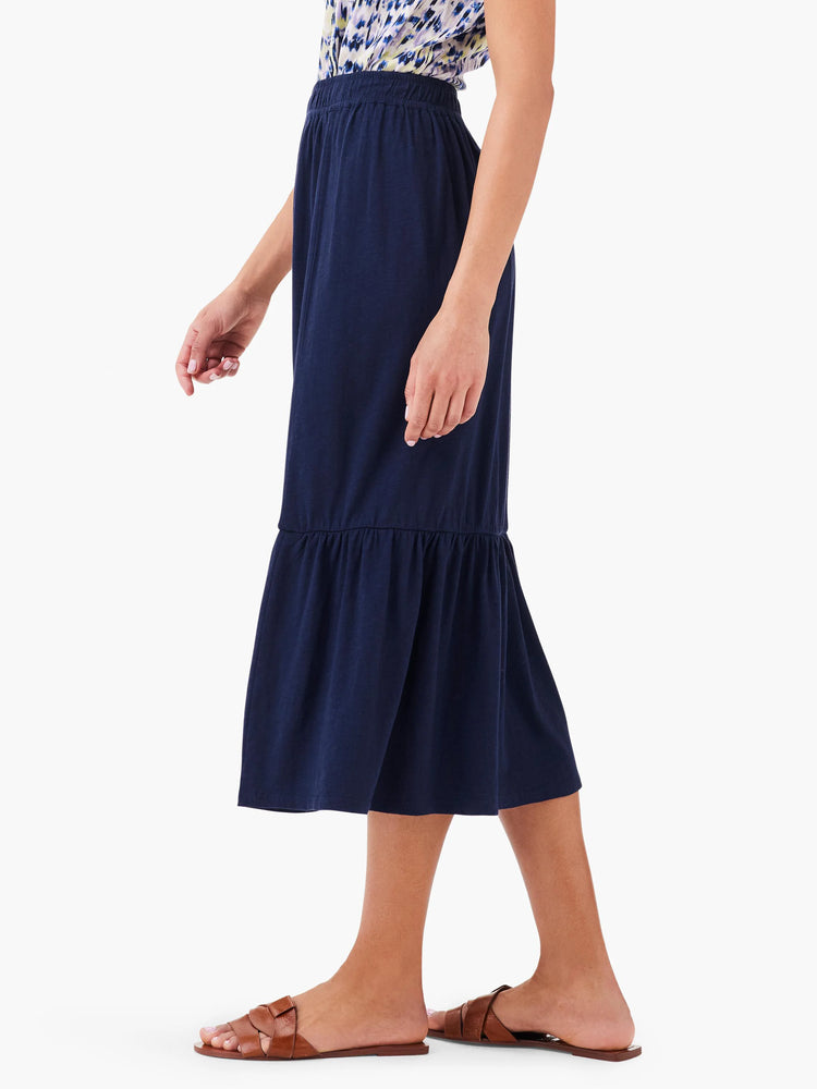 Navy blue tiered midi skirt; elastic waistband; mid-calf length.