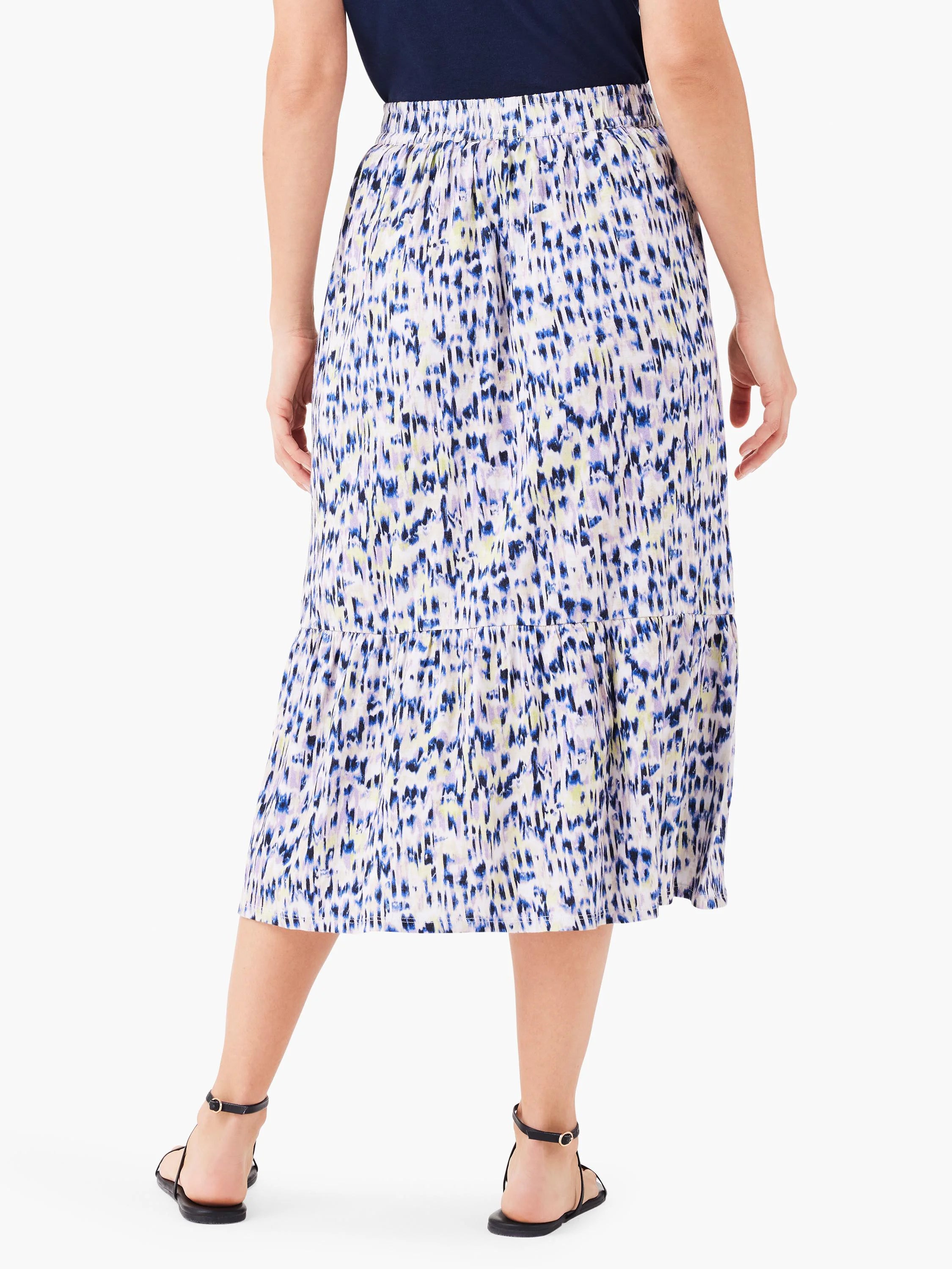 Midi skirt, tiered, white background with blue, purple, and pale yellow abstract print. Elastic waistband.