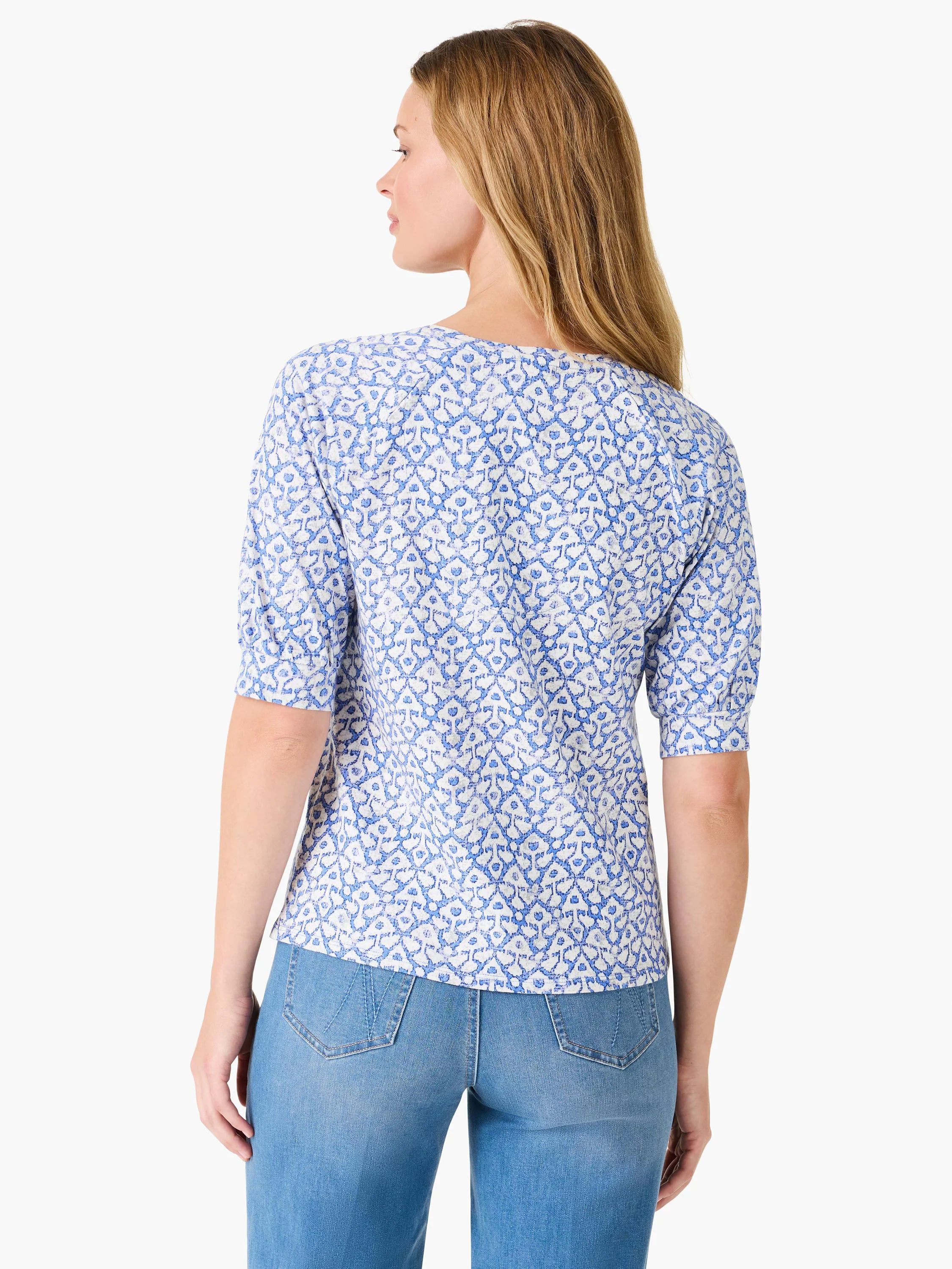 Back view of elbow-sleeve V-neck shirt. White background with blue, repeating ikat pattern.