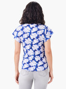 Short-sleeve blue tee with white leaf pattern.  Back view.