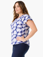 Short-sleeve blue tee with white leaf print, flutter sleeves.