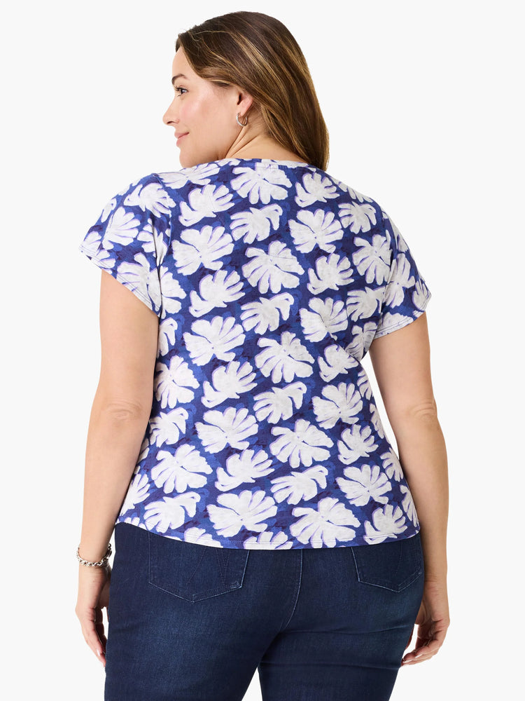 Short-sleeve tee, blue background with off-white leaf print. Short sleeves.
