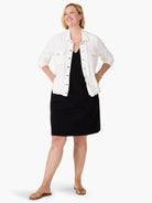 White denim-look jacket with tan contrast stitching, button front, and two chest pockets.