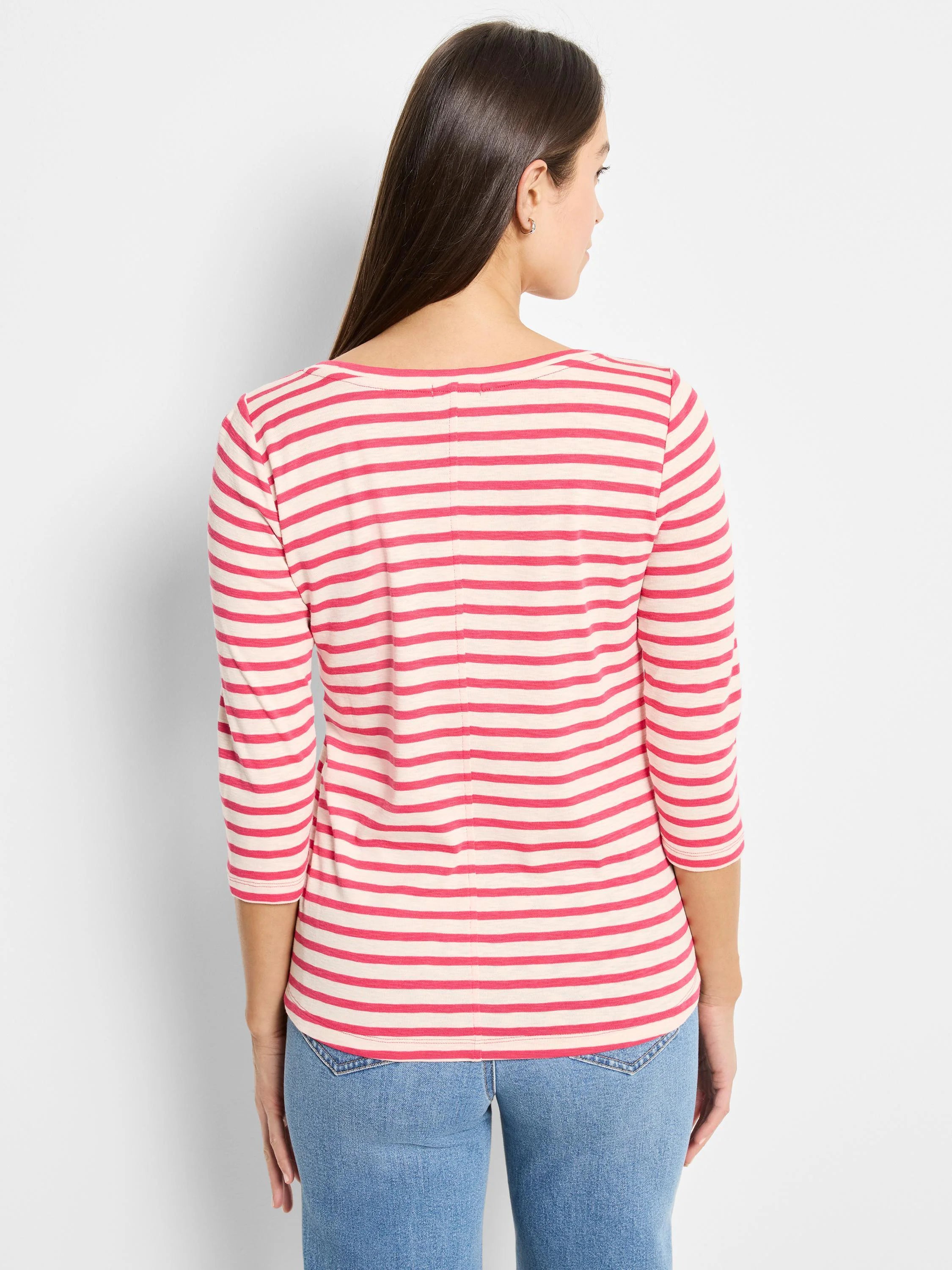Coral pink and cream striped 3/4 sleeve boat neck tee, worn by a woman facing away.