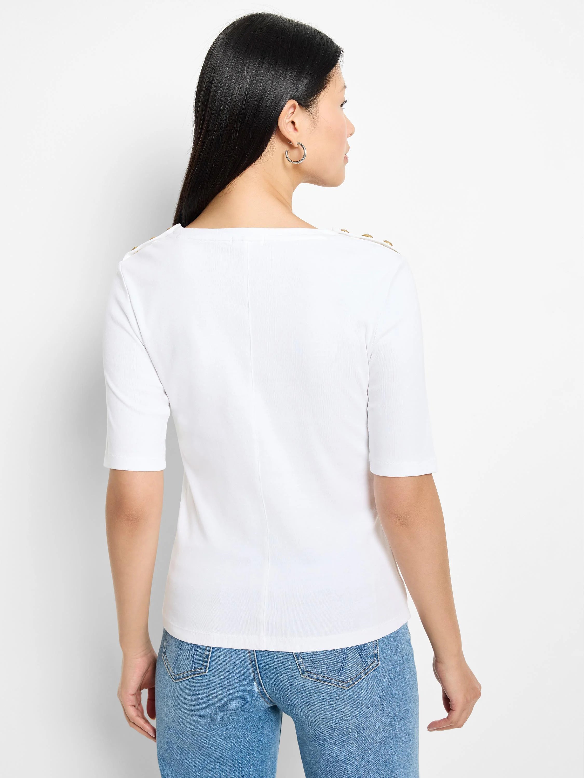 White elbow-length sleeve top with gold buttons on the shoulders. Back view.