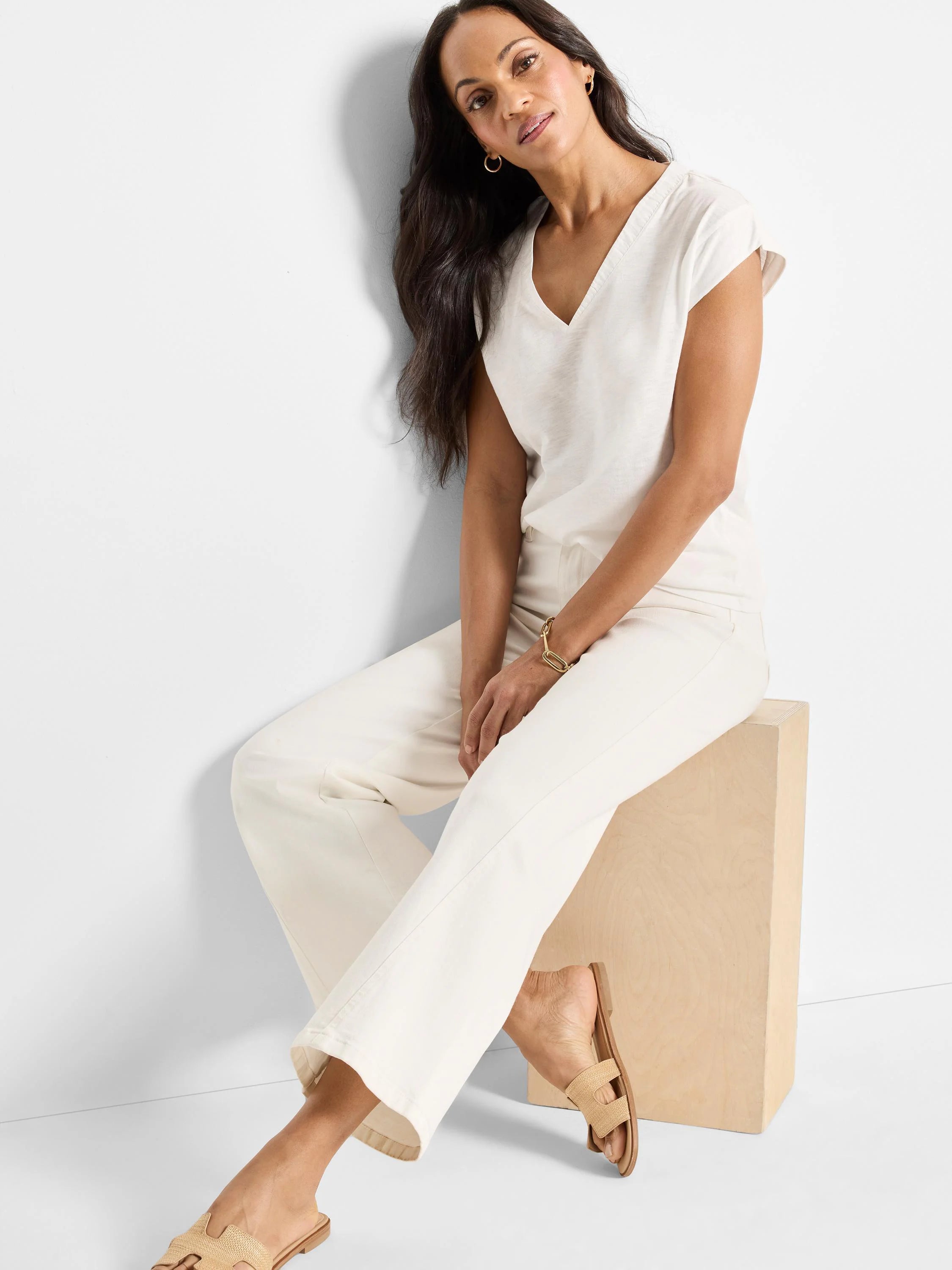 Cream V-neck tank top with short cap sleeves.