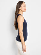 Here's alt text for the image, under 125 characters:
Navy blue sleeveless V-neck ribbed tank top; shown on a model.