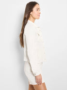 Off-white denim look jacket with button front, collar, chest flap pockets, and visible contrast stitching.
