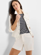 Off-white denim-look jacket with a collar, silver-toned buttons, breast pockets, and visible light contrast stitching.