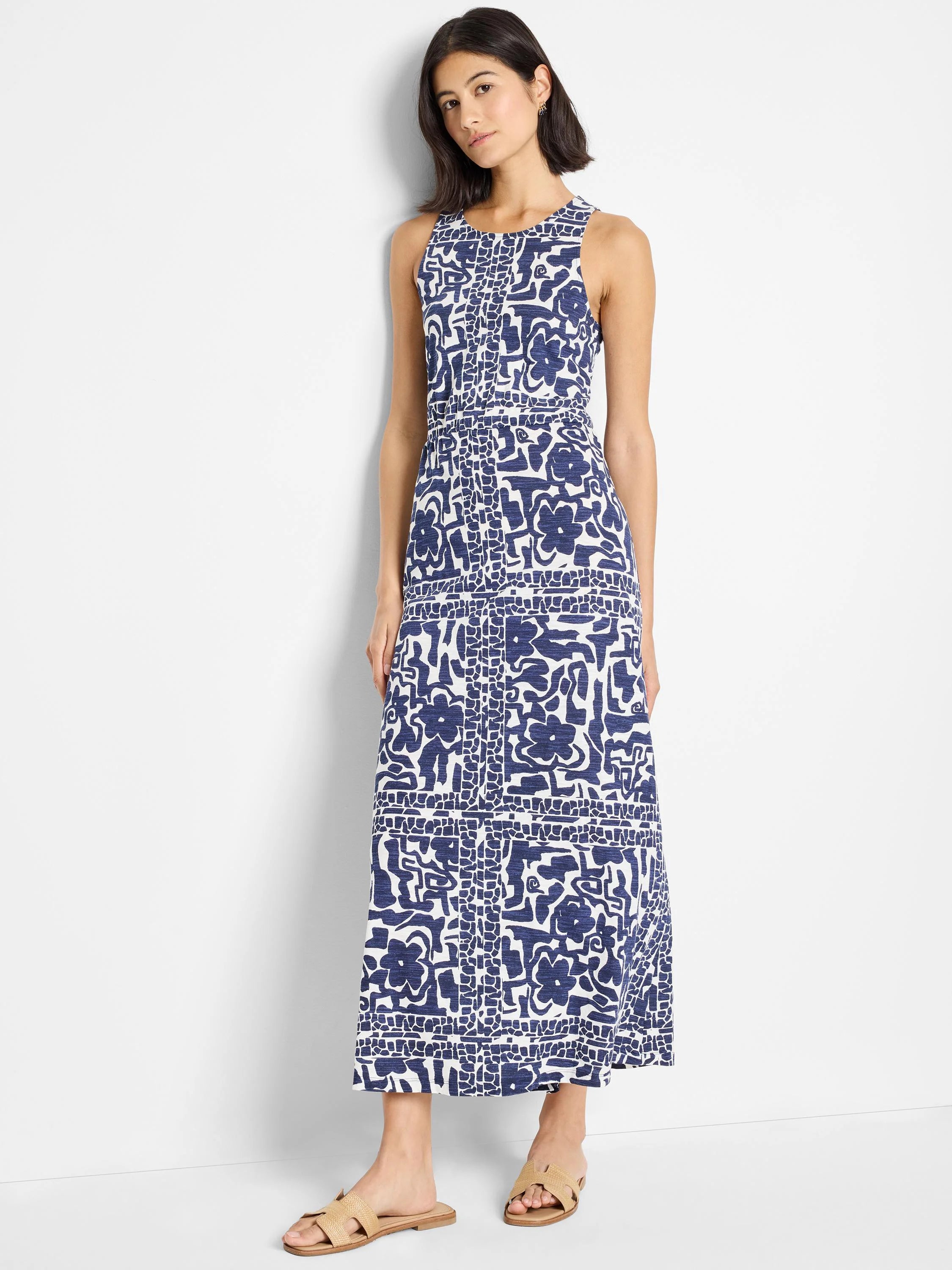 Navy blue and white abstract floral maxi dress; sleeveless, floor-length.