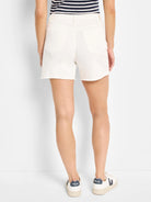 Off-white denim shorts; frayed hem; back view.
